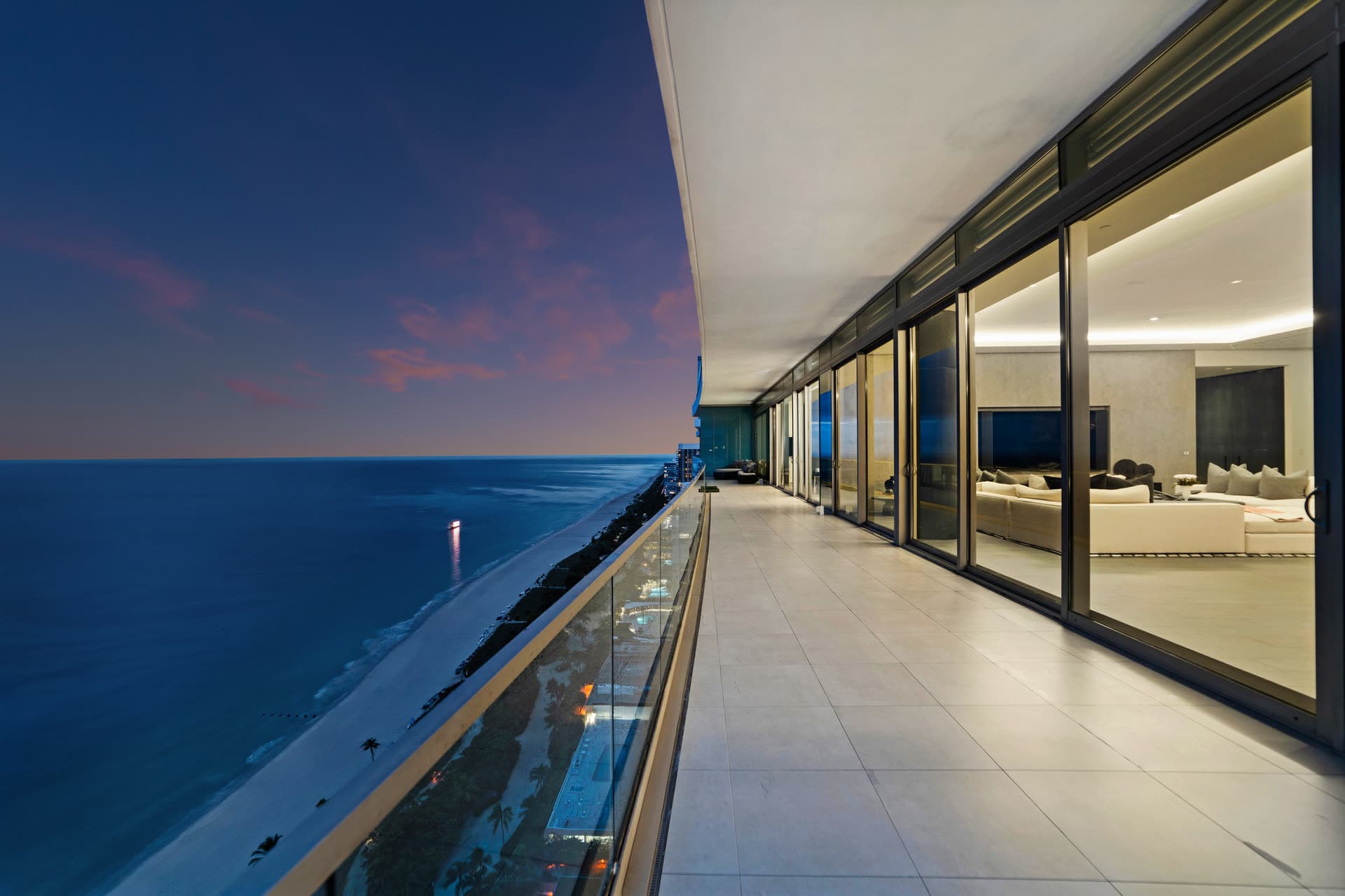Penthouse terrace overlooking the ocean at twilight